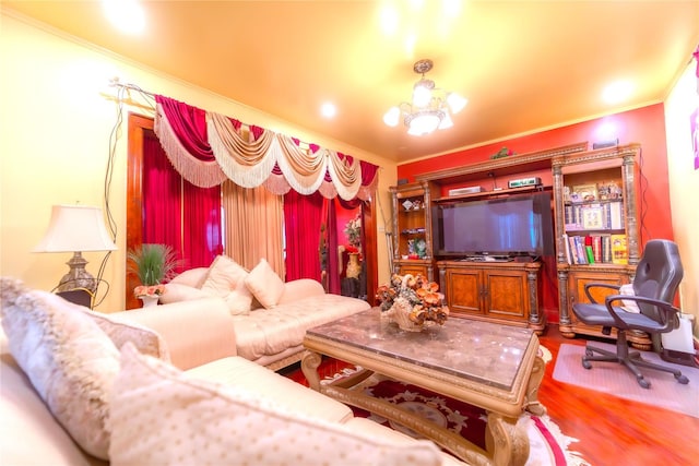 living room featuring wood-type flooring, ornamental molding, and an inviting chandelier