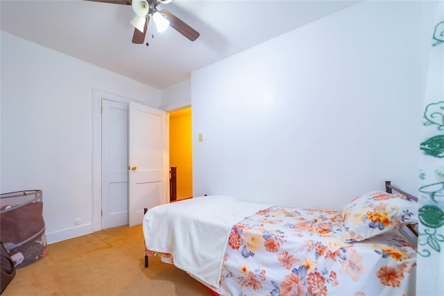 bedroom featuring ceiling fan and light colored carpet