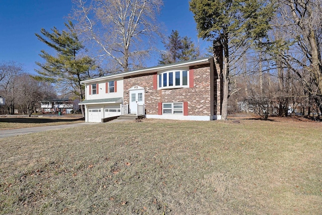 split foyer home with a front yard and a garage