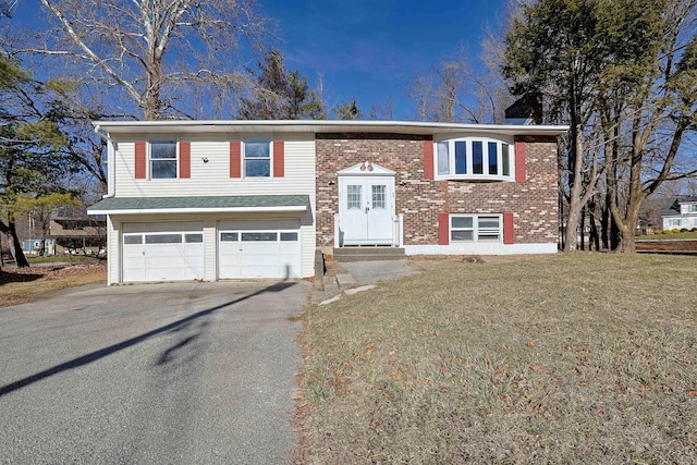 raised ranch with a garage and a front lawn