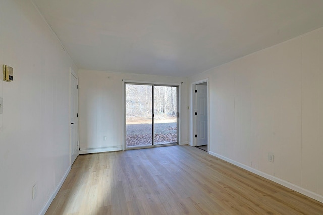 unfurnished room with light hardwood / wood-style flooring and a baseboard radiator