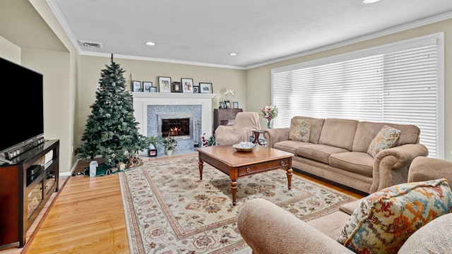 living room featuring light wood-type flooring and ornamental molding