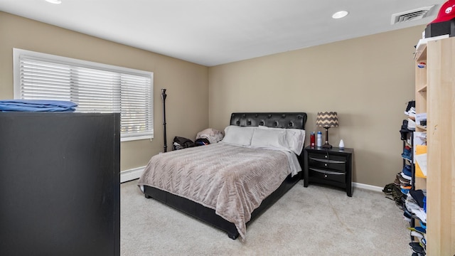 carpeted bedroom featuring baseboard heating