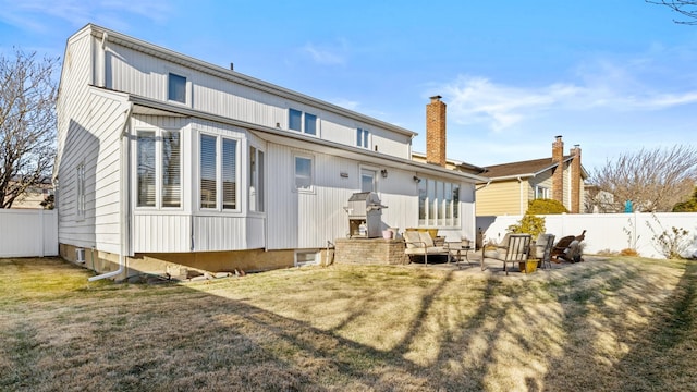 back of property featuring outdoor lounge area, a patio area, and a yard