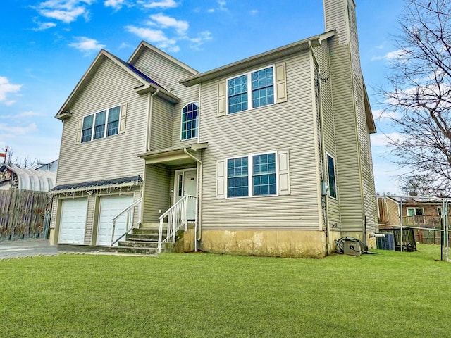 view of front of property featuring a garage and a front yard