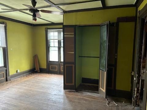 unfurnished room with ceiling fan, ornamental molding, and hardwood / wood-style floors