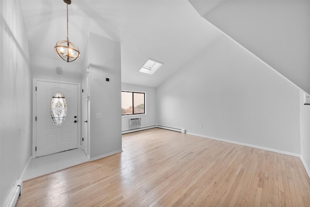 entryway with a notable chandelier, a baseboard heating unit, lofted ceiling, and light hardwood / wood-style flooring