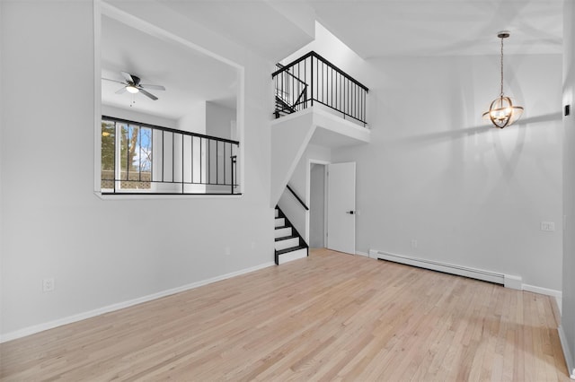 unfurnished living room with ceiling fan, light hardwood / wood-style flooring, and a baseboard radiator