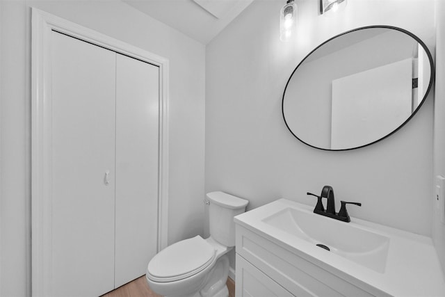 bathroom featuring hardwood / wood-style flooring, vanity, and toilet