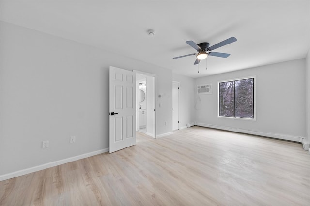 spare room featuring ceiling fan, light hardwood / wood-style floors, a wall unit AC, and a baseboard radiator