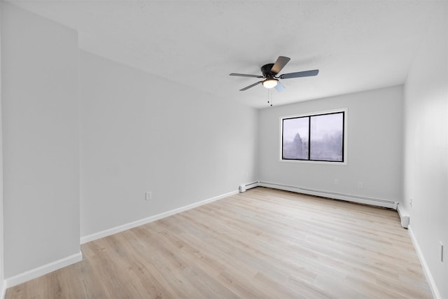 spare room featuring ceiling fan, light hardwood / wood-style flooring, and a baseboard radiator