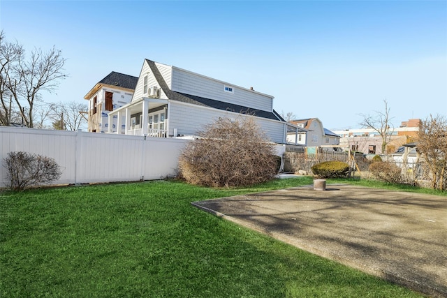 view of property exterior with a patio area and a lawn