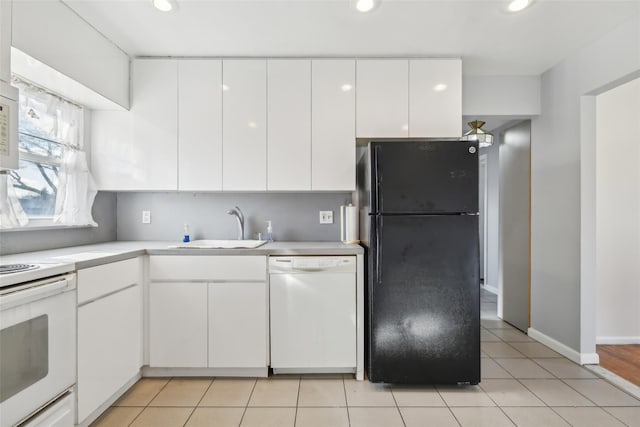 kitchen with white cabinetry, white appliances, light tile patterned flooring, and sink