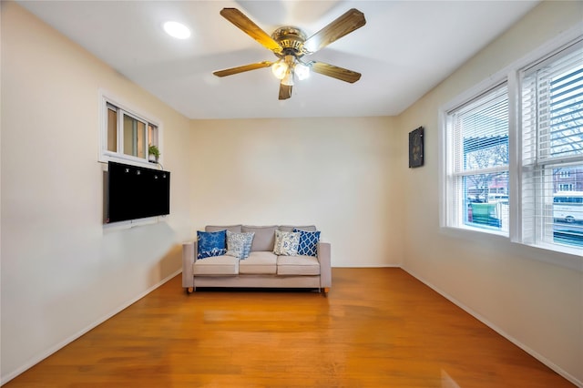 sitting room featuring ceiling fan and light wood-type flooring