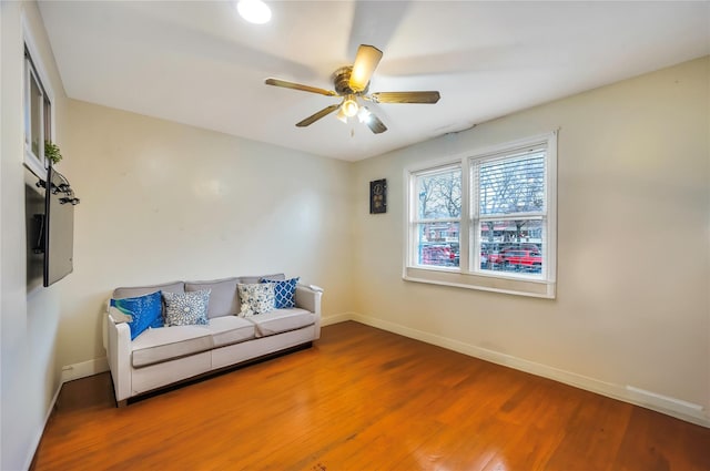 living area with ceiling fan and hardwood / wood-style floors