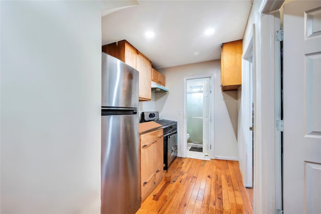 kitchen featuring stainless steel appliances and light hardwood / wood-style flooring