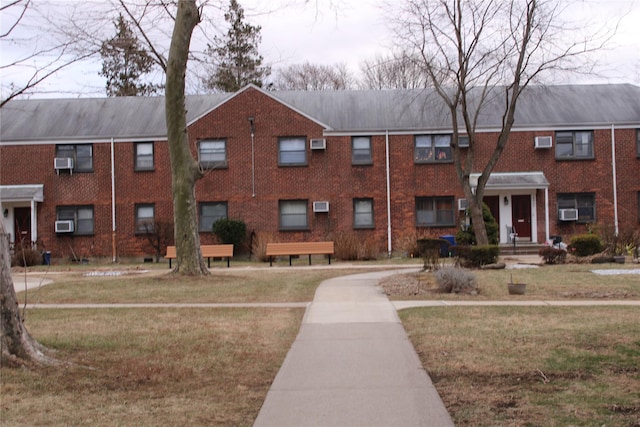 view of building exterior with a wall unit AC