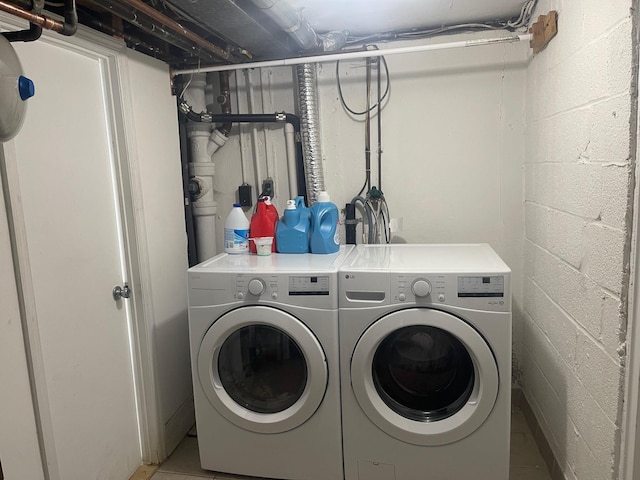 washroom featuring tile patterned floors and washing machine and dryer