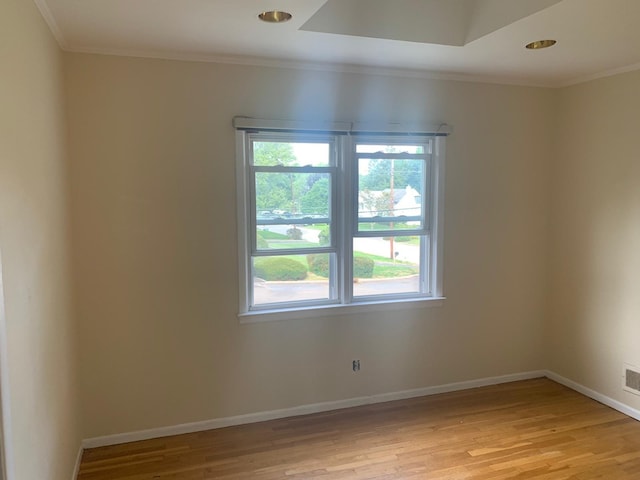 unfurnished room featuring light hardwood / wood-style floors and ornamental molding