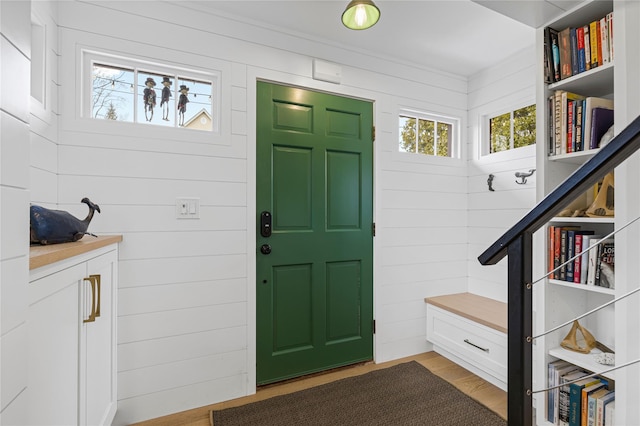 interior space with wood-type flooring and wooden walls