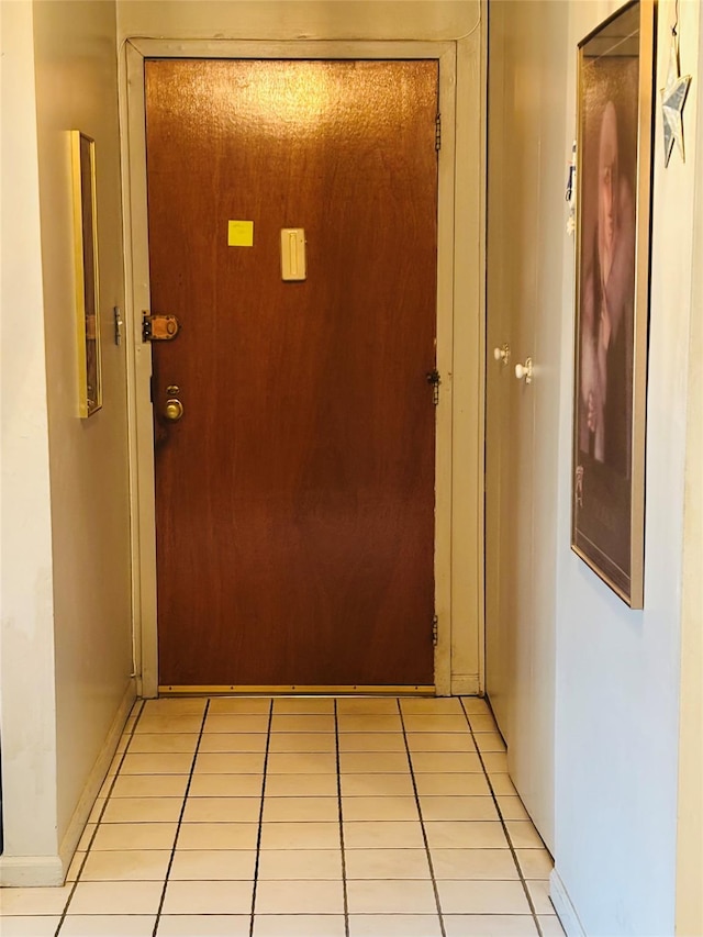 interior space featuring baseboards and light tile patterned floors