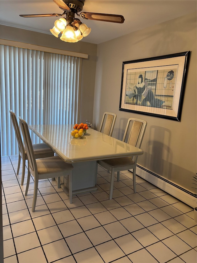 dining space with light tile patterned floors, ceiling fan, and a baseboard heating unit