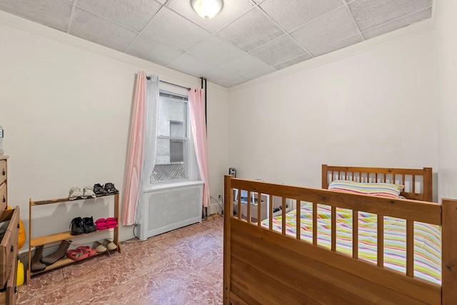 bedroom featuring a paneled ceiling and ornamental molding