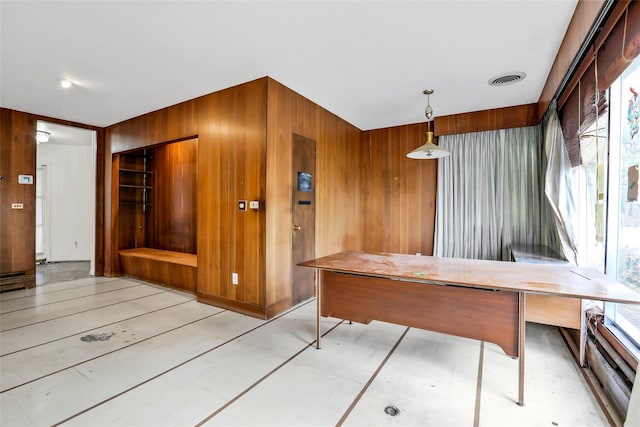 unfurnished dining area featuring wood walls