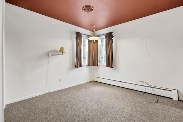 empty room with carpet and a baseboard heating unit