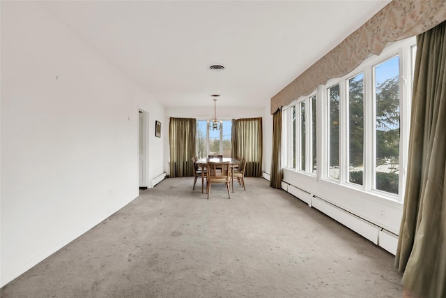 unfurnished sunroom featuring a baseboard radiator, an inviting chandelier, and plenty of natural light