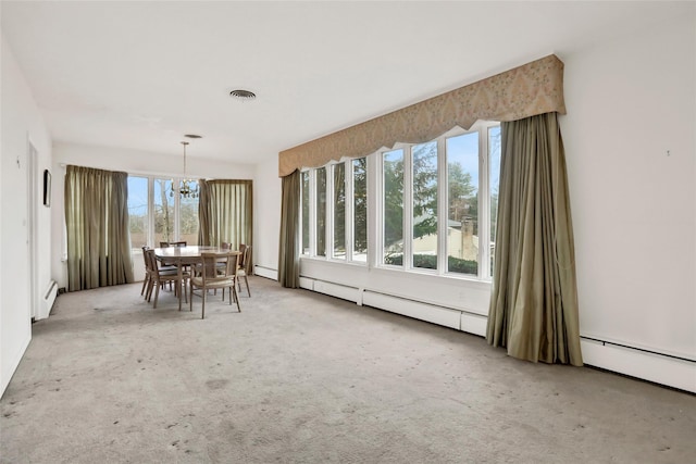 unfurnished dining area with carpet, a baseboard radiator, and an inviting chandelier