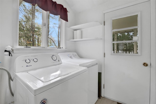 clothes washing area with washer and clothes dryer