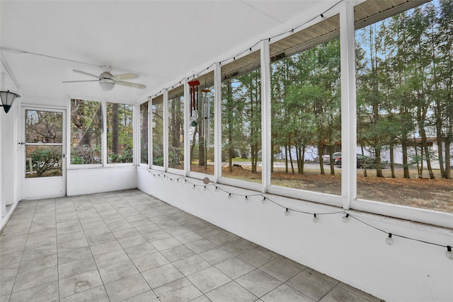 unfurnished sunroom with ceiling fan and a healthy amount of sunlight