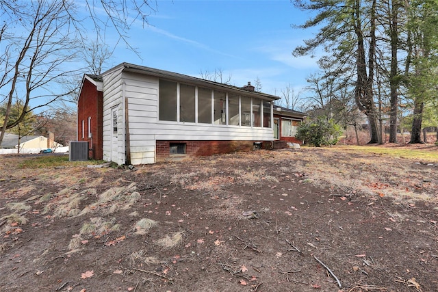 exterior space with a sunroom and central air condition unit