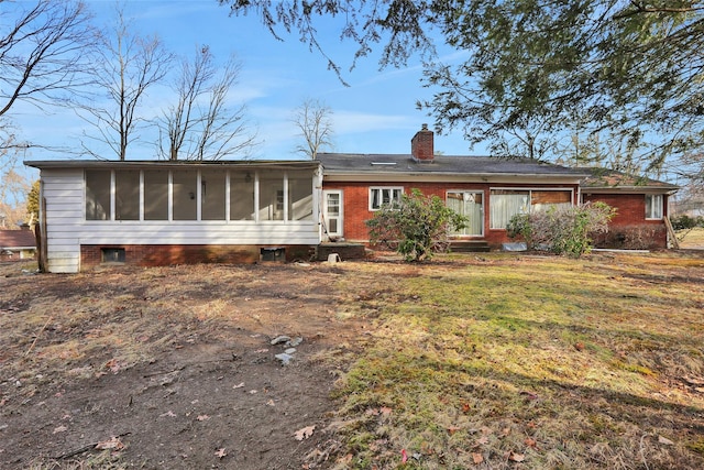 back of house featuring a sunroom and a yard