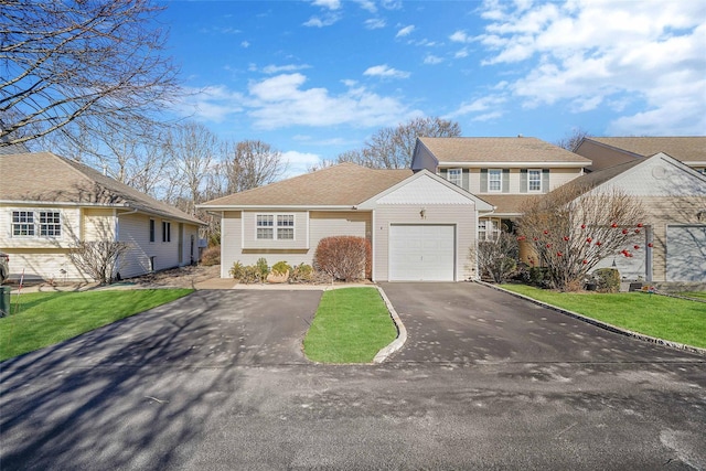 view of front of house featuring a garage and a front lawn