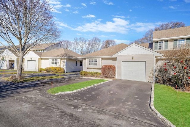 view of front of home with a garage and a front lawn