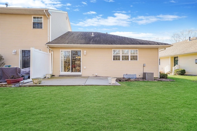 rear view of property featuring a yard, a patio, and central AC unit