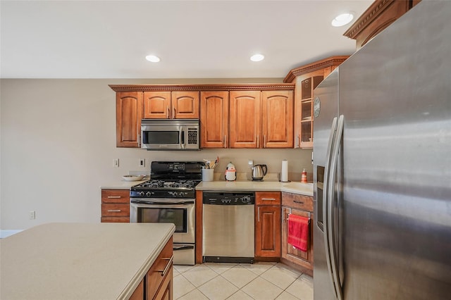 kitchen with light tile patterned floors and stainless steel appliances