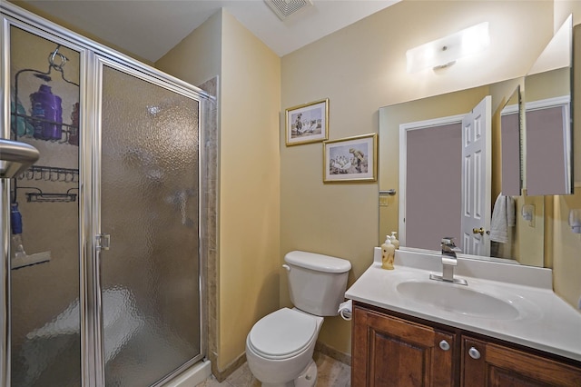 bathroom featuring vanity, toilet, and a shower with shower door