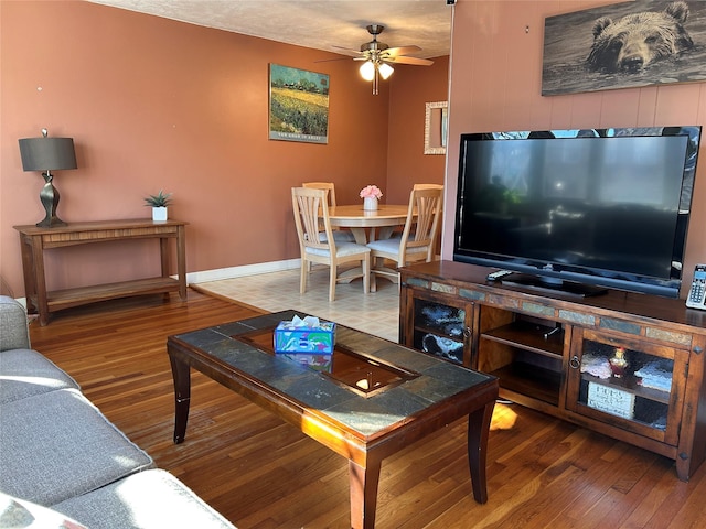 living room featuring hardwood / wood-style flooring and ceiling fan