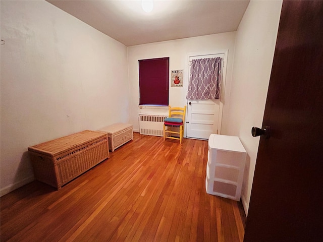 misc room with hardwood / wood-style floors and radiator heating unit