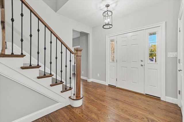 foyer featuring hardwood / wood-style floors and an inviting chandelier