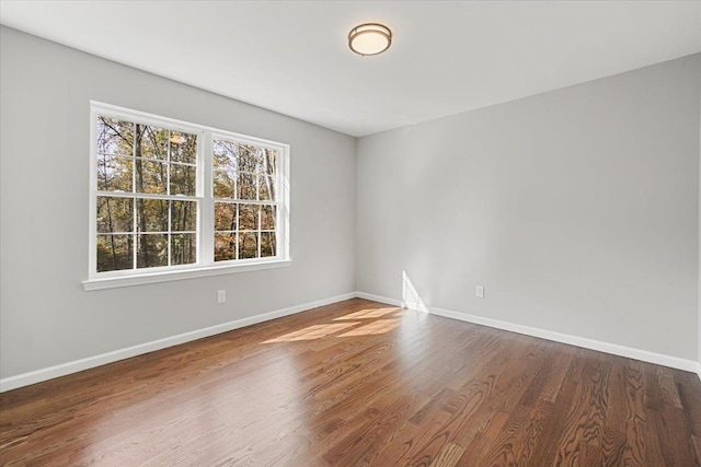 spare room with hardwood / wood-style floors