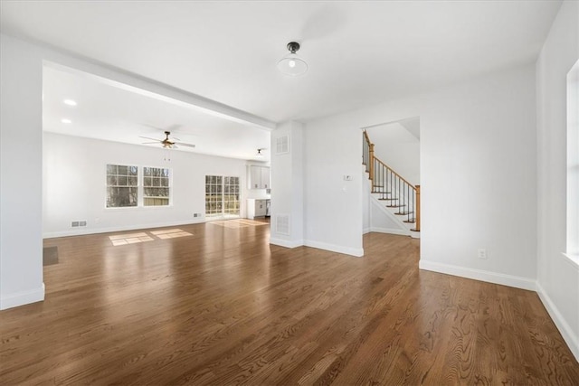 unfurnished living room featuring ceiling fan and wood-type flooring