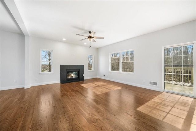 unfurnished living room with ceiling fan and wood-type flooring