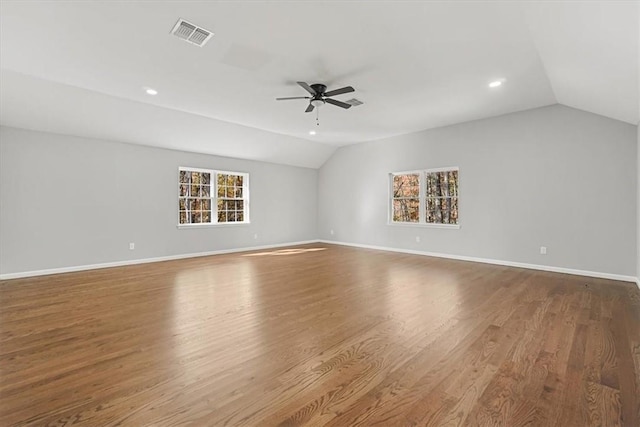 empty room featuring hardwood / wood-style floors, plenty of natural light, ceiling fan, and lofted ceiling