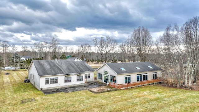 back of property featuring a patio and a lawn