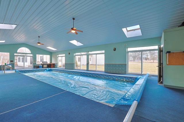 view of pool featuring ceiling fan and a skylight