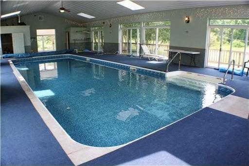 view of swimming pool featuring ceiling fan